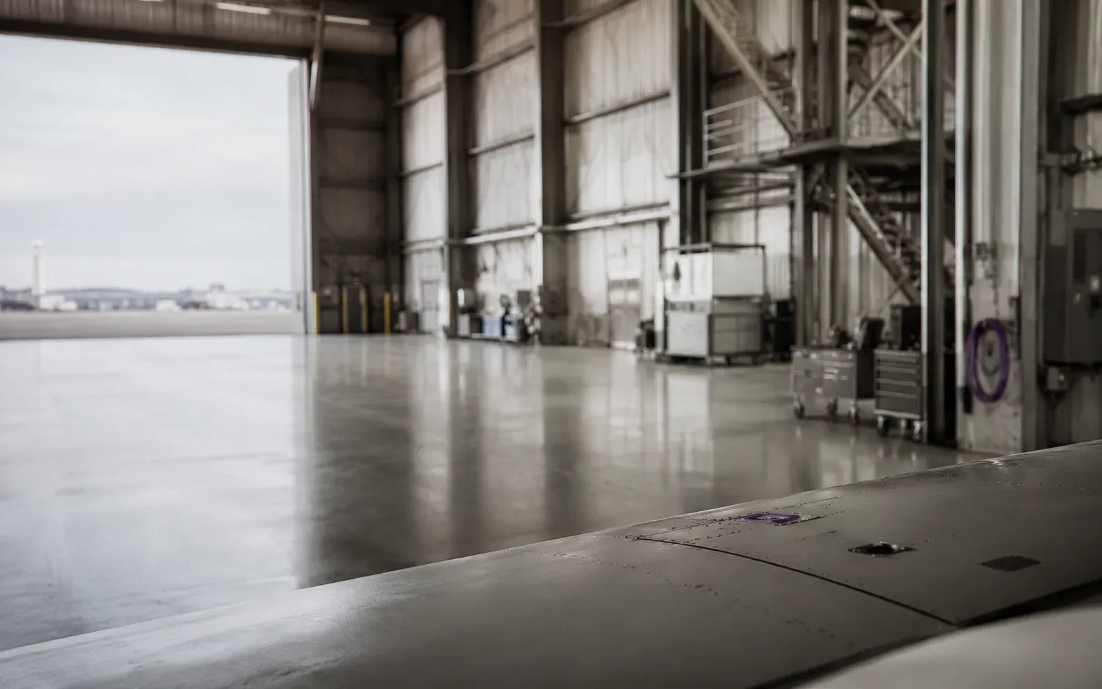 An aircraft hangar interior at first light
